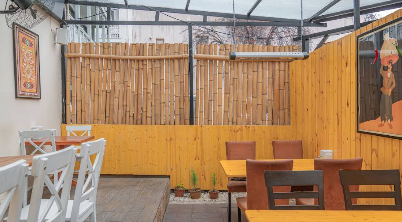 Covered Outdoor Terrace - Weather-protected dining at the best Restaurant in Tbilisi with bamboo privacy screens