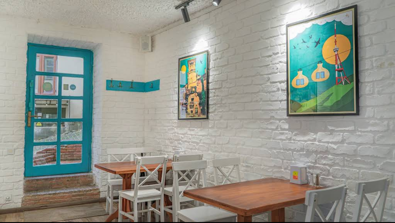 Interior with Georgian Artwork - Cultural fusion at Tajmahal Restaurant Tbilisi featuring local art and Indian hospitality