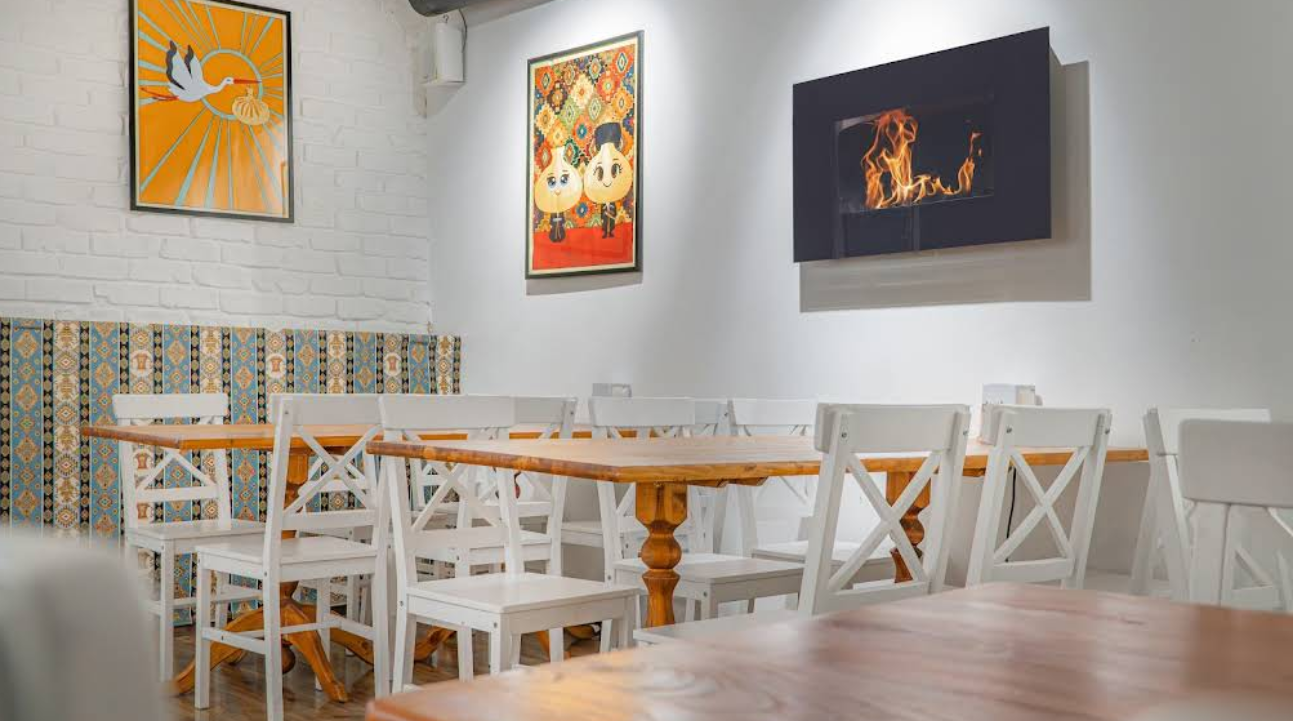 Main Dining Hall - Elegant interior design at Indian Restaurant in Tbilisi with traditional tile work and modern fireplace