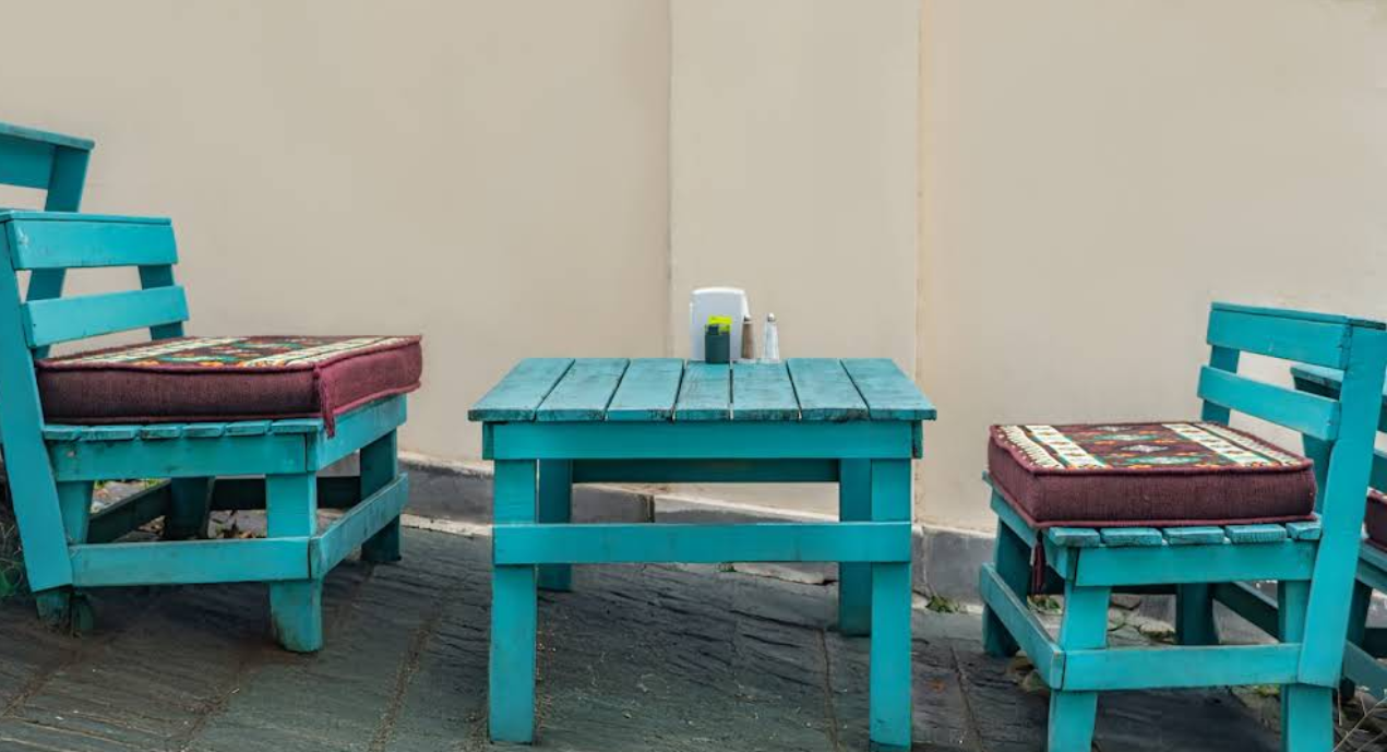 Outdoor Seating Detail - Comfortable turquoise furniture at the best Indian Restaurant in Tbilisi with traditional cushions